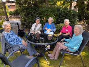 Residents and Staff Enjoying the Garden at Richmondwood Care Home in Bournemouth
